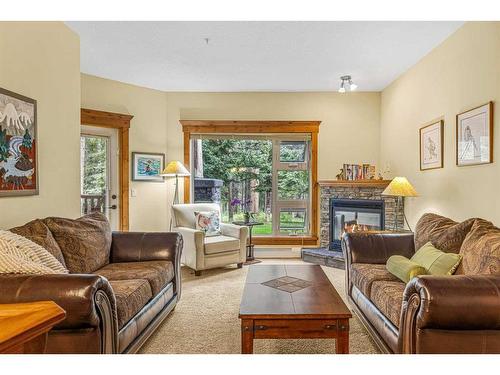 112-175 Crossbow Place, Canmore, AB - Indoor Photo Showing Living Room With Fireplace