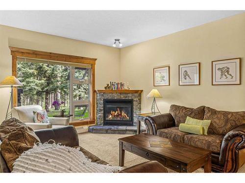 112-175 Crossbow Place, Canmore, AB - Indoor Photo Showing Living Room With Fireplace