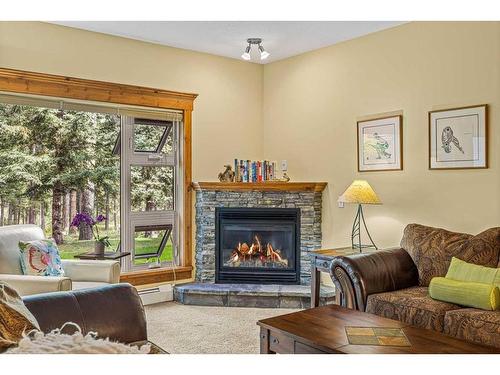 112-175 Crossbow Place, Canmore, AB - Indoor Photo Showing Living Room With Fireplace