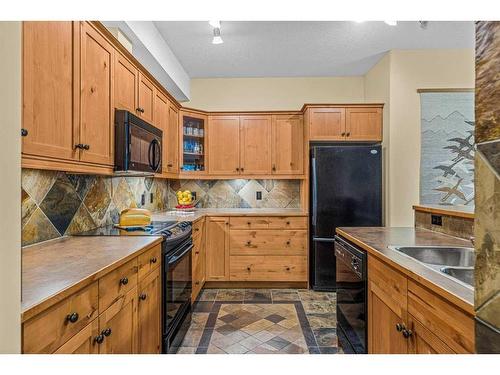 112-175 Crossbow Place, Canmore, AB - Indoor Photo Showing Kitchen With Double Sink