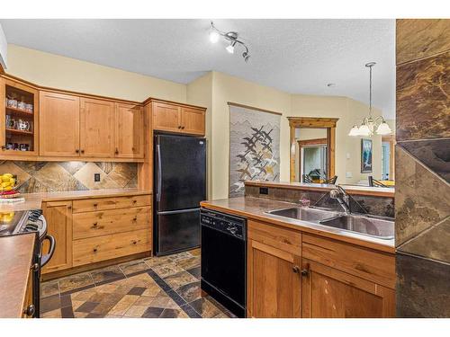 112-175 Crossbow Place, Canmore, AB - Indoor Photo Showing Kitchen With Double Sink