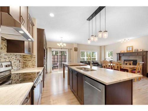 5 Morgan Street, Cochrane, AB - Indoor Photo Showing Kitchen With Fireplace With Double Sink