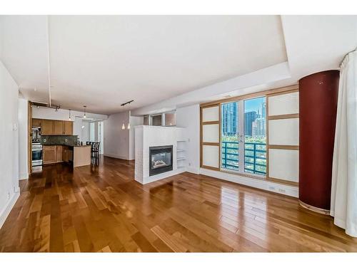 401-205 Riverfront Avenue Sw, Calgary, AB - Indoor Photo Showing Living Room With Fireplace