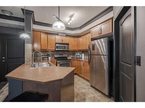 109-15304 Bannister Road Se, Calgary, AB - Indoor Photo Showing Kitchen With Double Sink