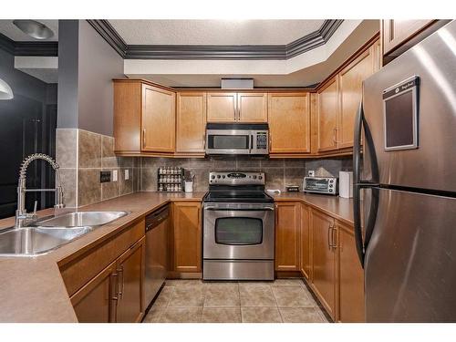 109-15304 Bannister Road Se, Calgary, AB - Indoor Photo Showing Kitchen With Double Sink