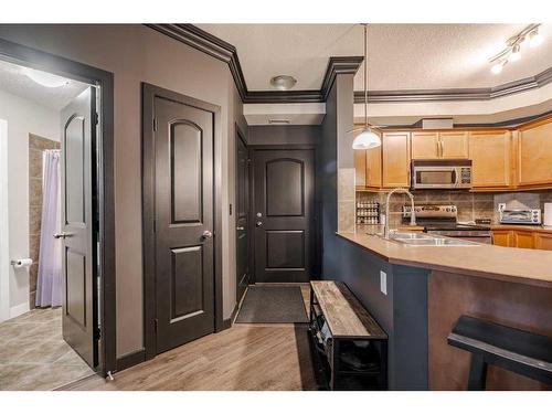 109-15304 Bannister Road Se, Calgary, AB - Indoor Photo Showing Kitchen With Double Sink