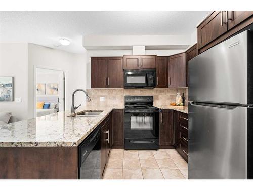 1107-1540 Sherwood Boulevard Nw, Calgary, AB - Indoor Photo Showing Kitchen With Double Sink With Upgraded Kitchen