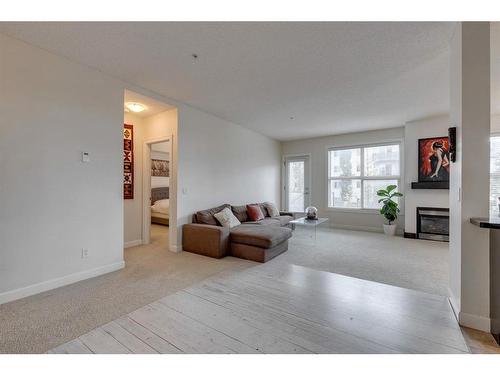 206-88 Arbour Lake Road Nw, Calgary, AB - Indoor Photo Showing Living Room With Fireplace