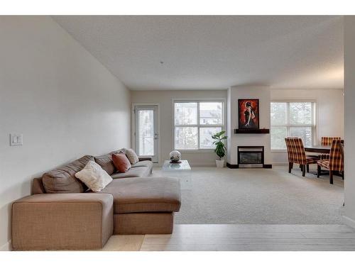 206-88 Arbour Lake Road Nw, Calgary, AB - Indoor Photo Showing Living Room With Fireplace