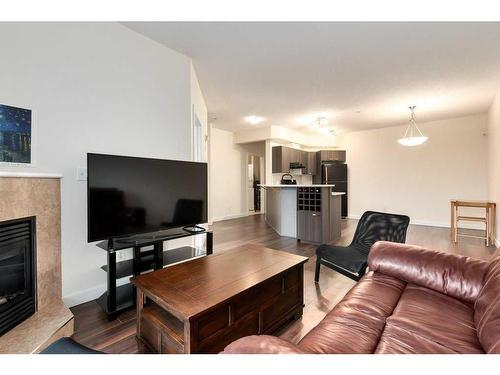 210-1800 14A Street Sw, Calgary, AB - Indoor Photo Showing Living Room With Fireplace