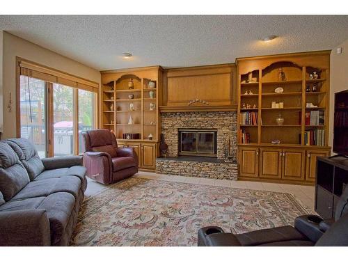 319 Edenwold Drive Nw, Calgary, AB - Indoor Photo Showing Living Room With Fireplace