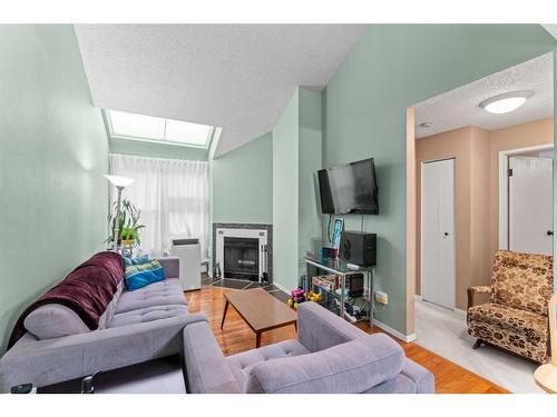 308-2218 30 Street Sw, Calgary, AB - Indoor Photo Showing Living Room With Fireplace