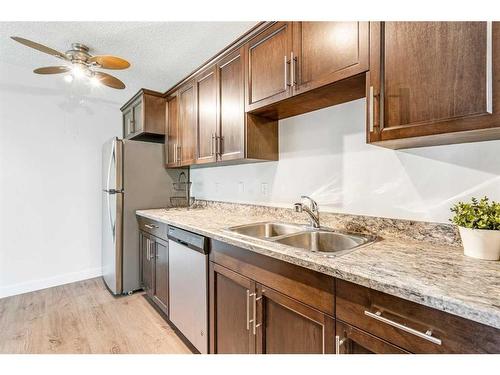 406-635 56 Avenue Sw, Calgary, AB - Indoor Photo Showing Kitchen With Double Sink