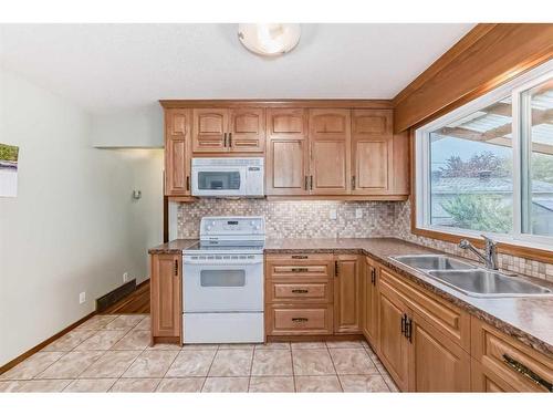 9216 Allison Drive Se, Calgary, AB - Indoor Photo Showing Kitchen With Double Sink