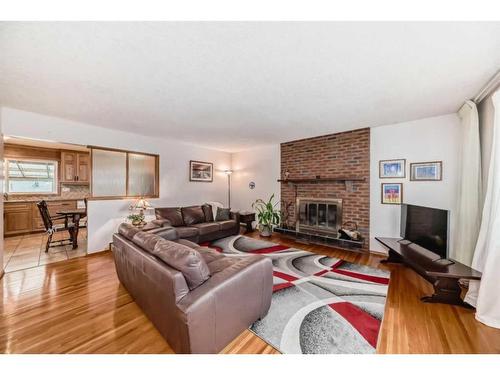 9216 Allison Drive Se, Calgary, AB - Indoor Photo Showing Living Room With Fireplace