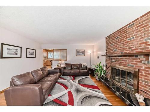 9216 Allison Drive Se, Calgary, AB - Indoor Photo Showing Living Room With Fireplace