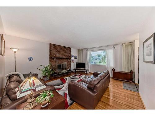 9216 Allison Drive Se, Calgary, AB - Indoor Photo Showing Living Room With Fireplace