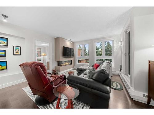 8406-400 Eau Claire Avenue Sw, Calgary, AB - Indoor Photo Showing Living Room With Fireplace