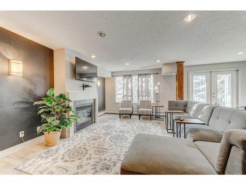 254-35 Richard Court Sw, Calgary, AB - Indoor Photo Showing Living Room With Fireplace