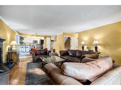 240 Wood Valley Drive Sw, Calgary, AB - Indoor Photo Showing Living Room With Fireplace