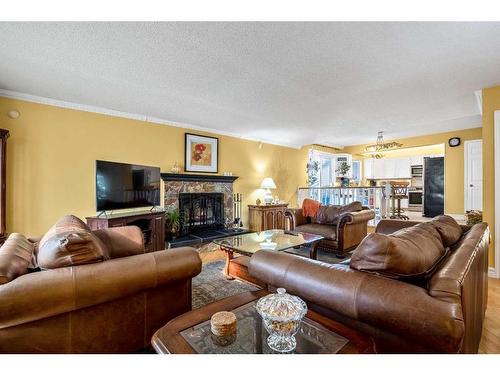 240 Wood Valley Drive Sw, Calgary, AB - Indoor Photo Showing Living Room With Fireplace