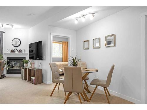 227-69 Springborough Court Sw, Calgary, AB - Indoor Photo Showing Dining Room With Fireplace