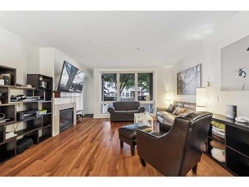 104-41 6A Street Ne, Calgary, AB - Indoor Photo Showing Living Room With Fireplace