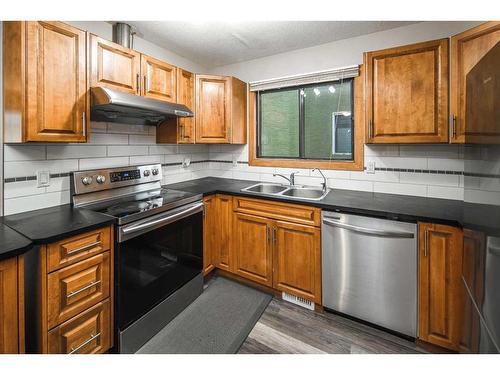 68 Woodglen Close Sw, Calgary, AB - Indoor Photo Showing Kitchen With Double Sink