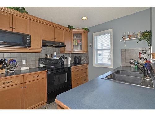 226 Evansmeade Close Nw, Calgary, AB - Indoor Photo Showing Kitchen With Double Sink