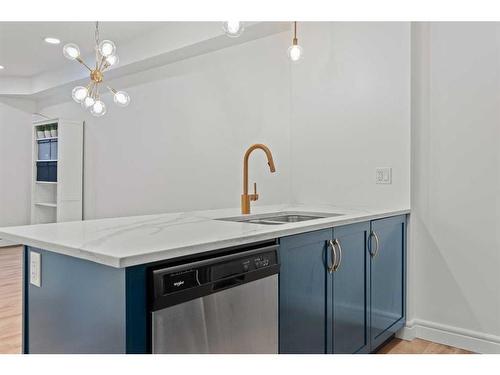 101-19621 40 Street Se, Calgary, AB - Indoor Photo Showing Kitchen With Double Sink