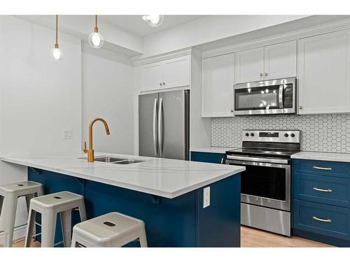 101-19621 40 Street Se, Calgary, AB - Indoor Photo Showing Kitchen With Stainless Steel Kitchen With Double Sink With Upgraded Kitchen