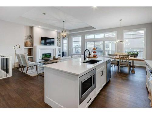 2205 Bayside Road Sw, Airdrie, AB - Indoor Photo Showing Kitchen With Fireplace With Double Sink