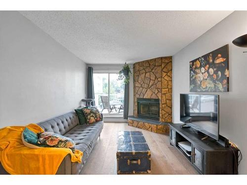 303-1919 17 Avenue Sw, Calgary, AB - Indoor Photo Showing Living Room With Fireplace