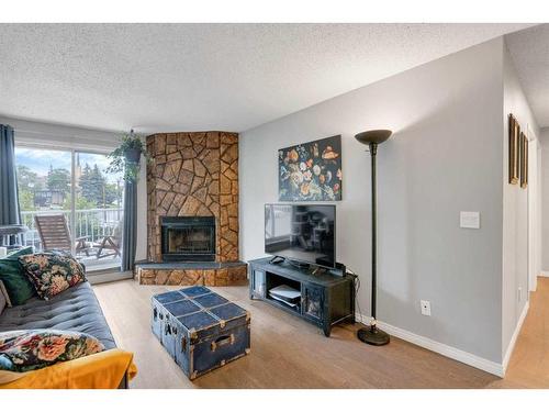 303-1919 17 Avenue Sw, Calgary, AB - Indoor Photo Showing Living Room With Fireplace