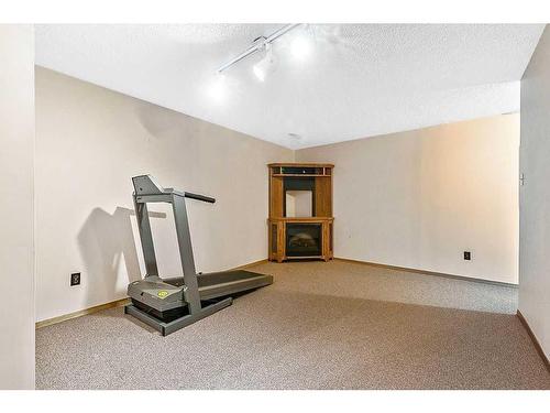 1 Hunters Crescent, Okotoks, AB - Indoor Photo Showing Gym Room