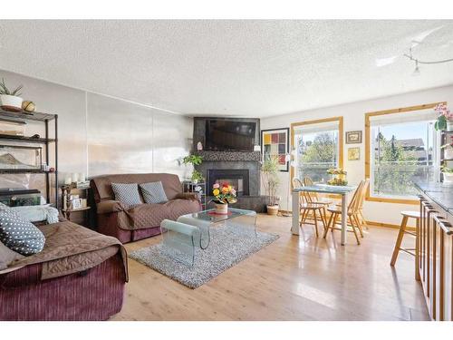 215 Shawcliffe Circle Sw, Calgary, AB - Indoor Photo Showing Living Room With Fireplace