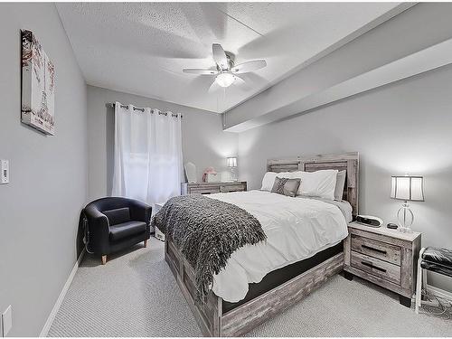 205-400 1 Avenue Se, Diamond Valley, AB - Indoor Photo Showing Bedroom