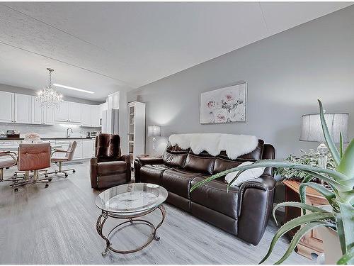 205-400 1 Avenue Se, Diamond Valley, AB - Indoor Photo Showing Living Room