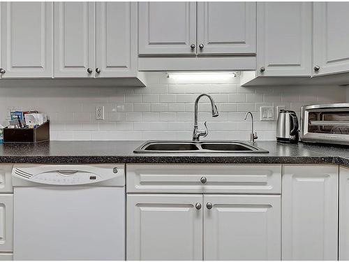 205-400 1 Avenue Se, Diamond Valley, AB - Indoor Photo Showing Kitchen With Double Sink