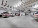 205-400 1 Avenue Se, Diamond Valley, AB  - Indoor Photo Showing Garage 