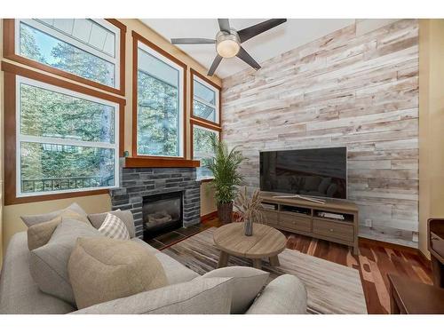 242 Benchlands Terrace, Canmore, AB - Indoor Photo Showing Living Room With Fireplace