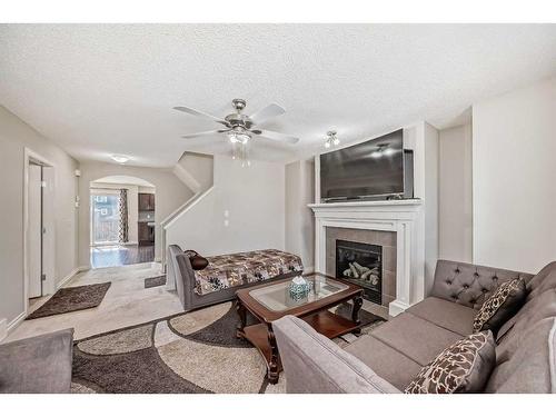 120 Saddlebrook Circle Ne, Calgary, AB - Indoor Photo Showing Living Room With Fireplace