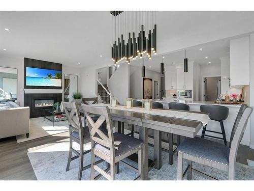 18 Savoy Landing Se, Calgary, AB - Indoor Photo Showing Dining Room With Fireplace