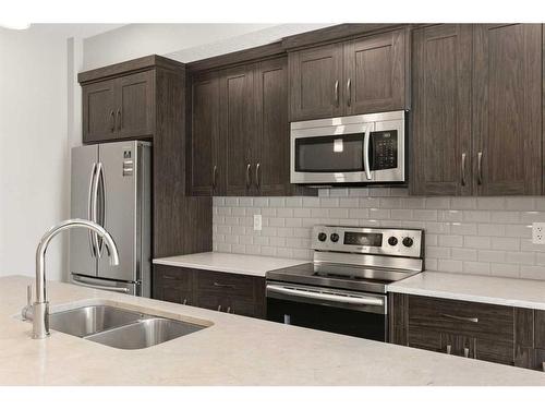 101-370 Harvest Hills Common Ne, Calgary, AB - Indoor Photo Showing Kitchen With Stainless Steel Kitchen With Double Sink With Upgraded Kitchen