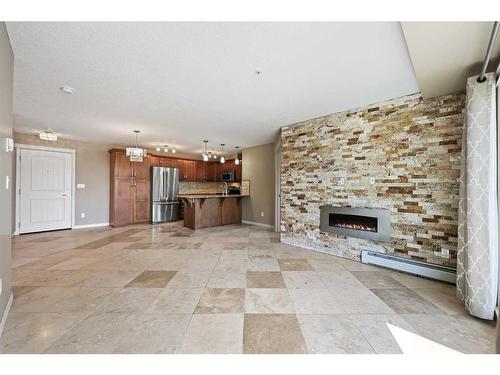 1106-450 Sage Valley Drive Nw, Calgary, AB - Indoor Photo Showing Living Room With Fireplace