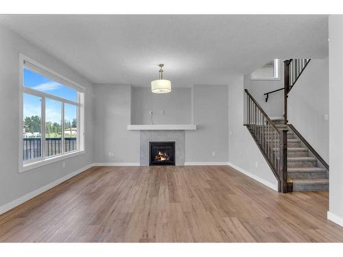 109 Kinniburgh Cove, Chestermere, AB - Indoor Photo Showing Living Room With Fireplace