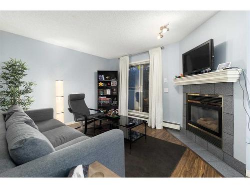 1-1928 26 Street Sw, Calgary, AB - Indoor Photo Showing Living Room With Fireplace