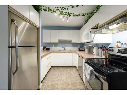 1-1928 26 Street Sw, Calgary, AB - Indoor Photo Showing Kitchen With Stainless Steel Kitchen With Double Sink