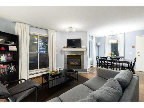 1-1928 26 Street Sw, Calgary, AB - Indoor Photo Showing Living Room With Fireplace