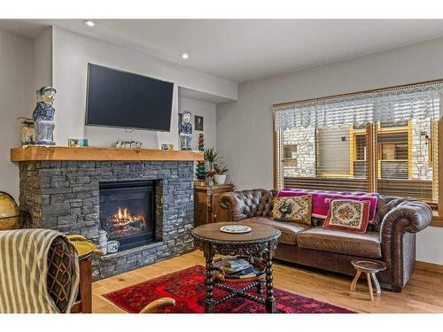 103-707 Spring Creek Drive, Canmore, AB - Indoor Photo Showing Living Room With Fireplace